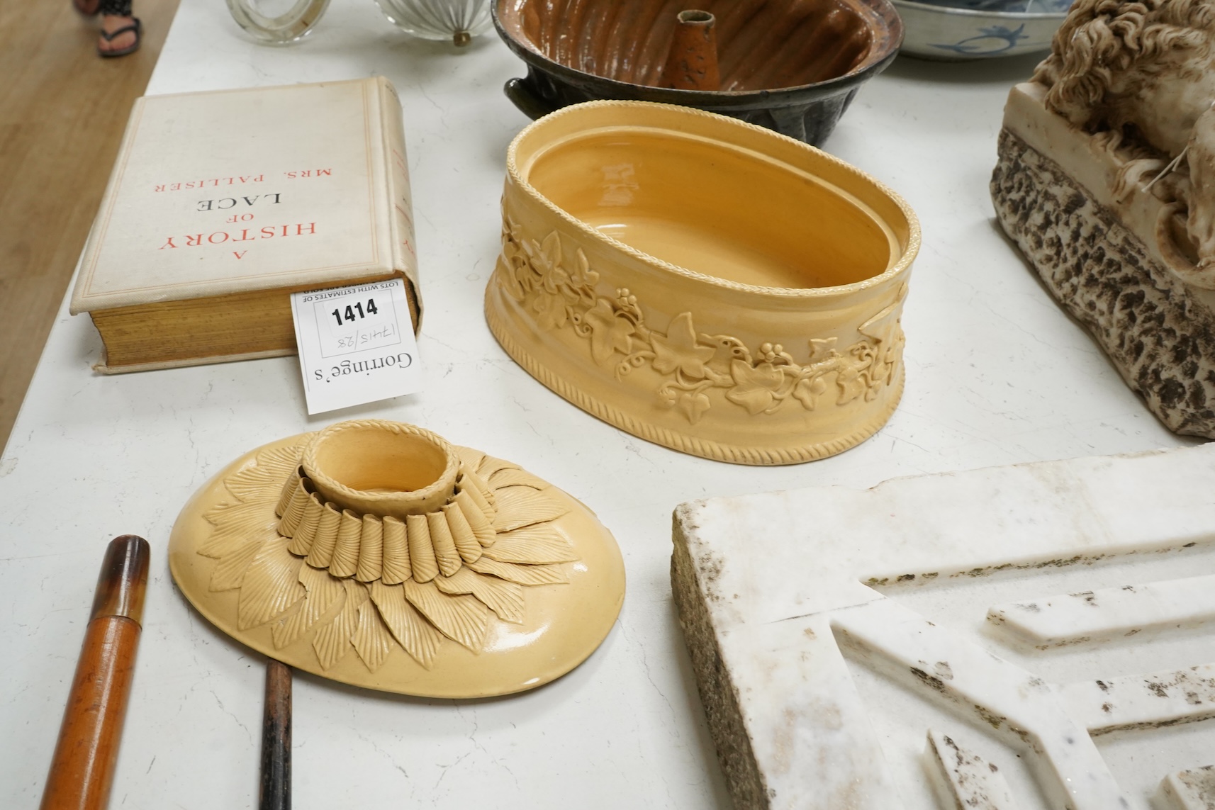 A 19th century oval caneware game/pie dish and cover, 24cm wide with an antique cake mould, (2)